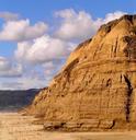 Half Moon Bay beach, cliffs, and blue skies.